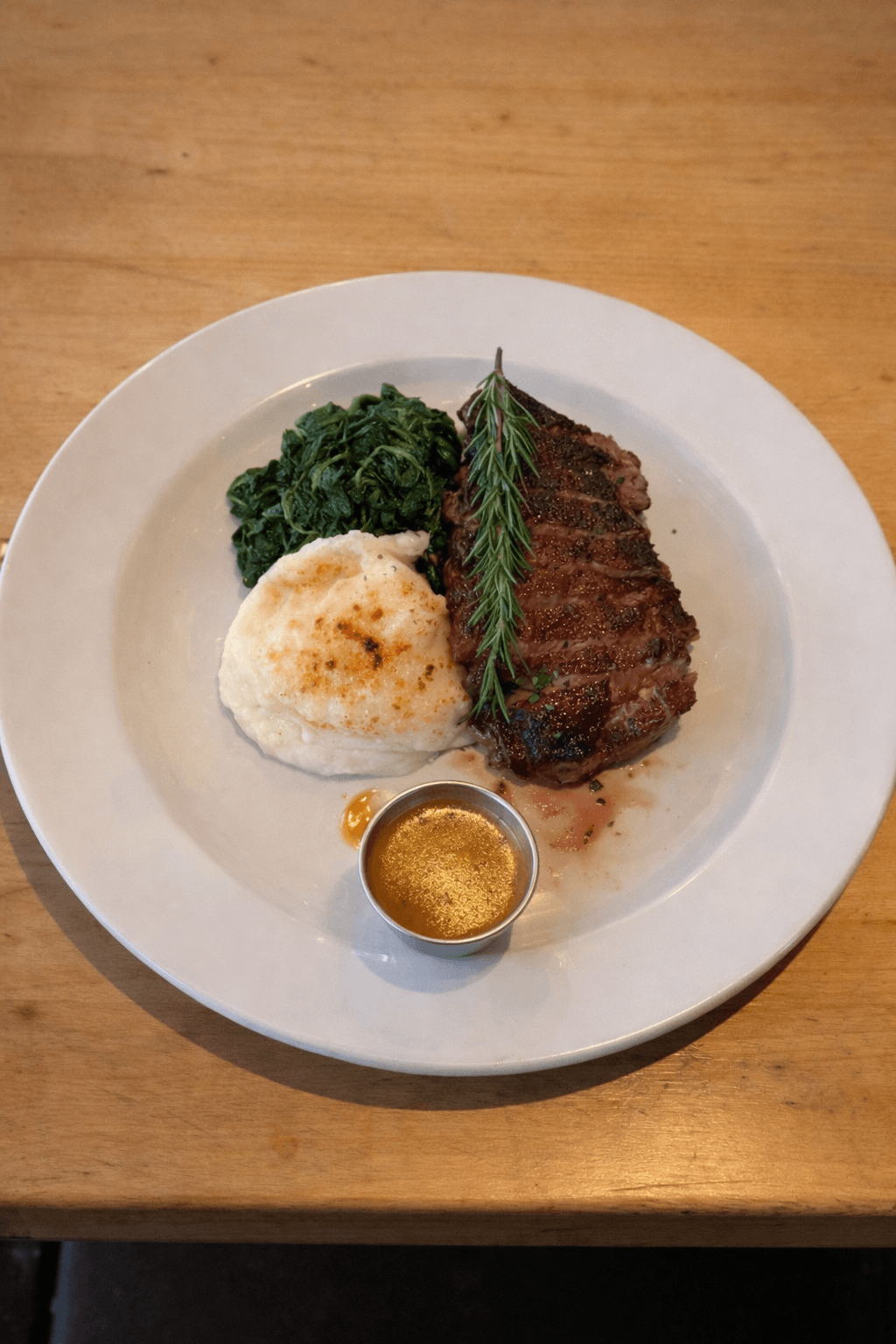 New York Strip Steak with Mashed Potatoes and Sautéed Spinach